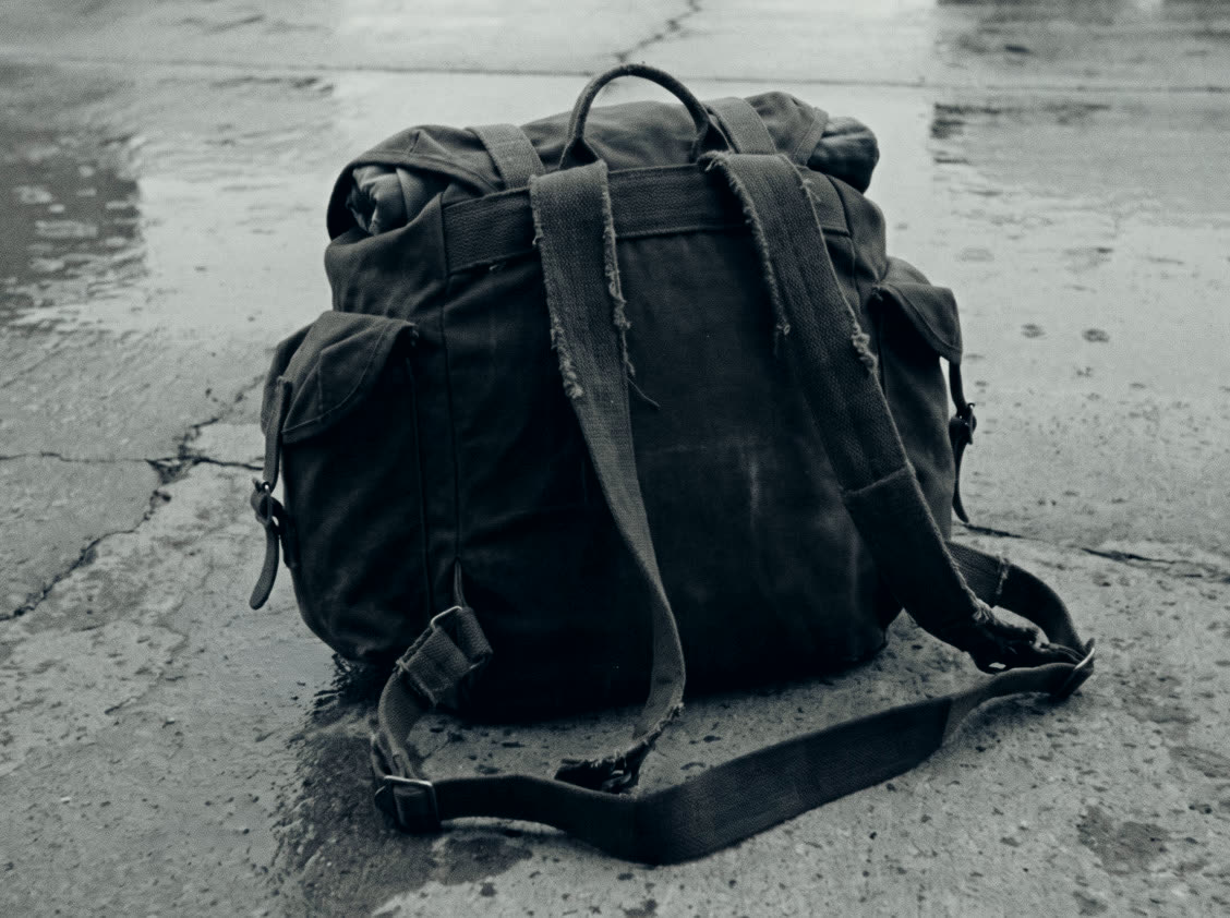 A loaded ruck on wet concrete.